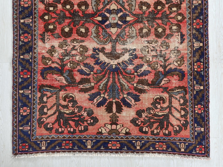 a red rug with a blue border on a white background