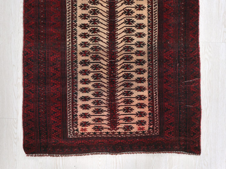 a red and beige rug on a white floor