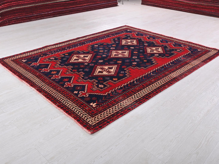 a red and black rug on a white floor