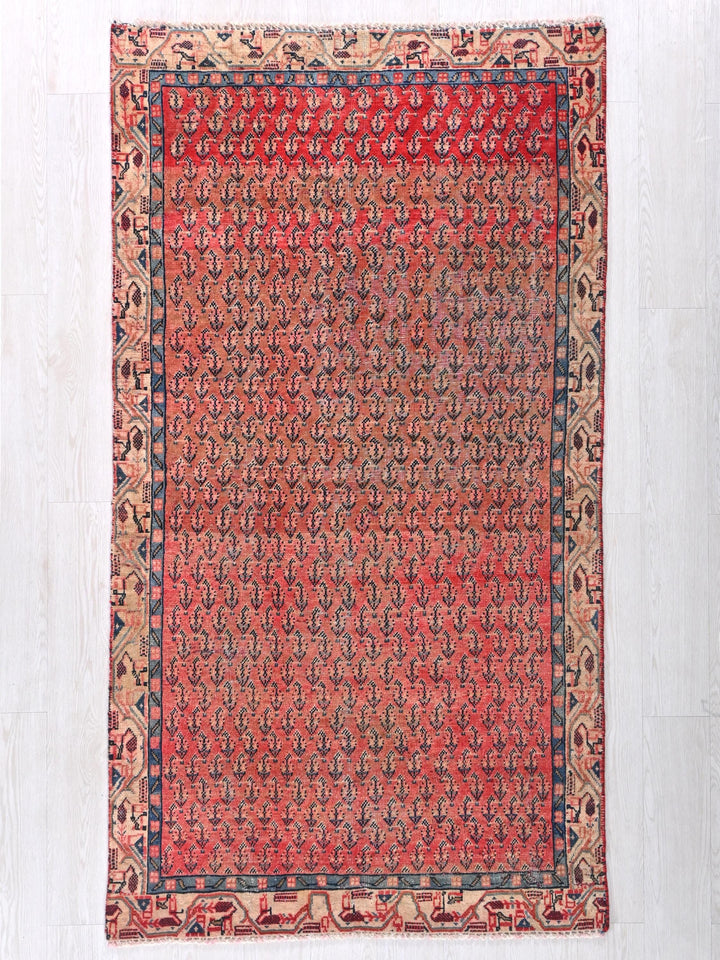 a red and blue rug on a white floor