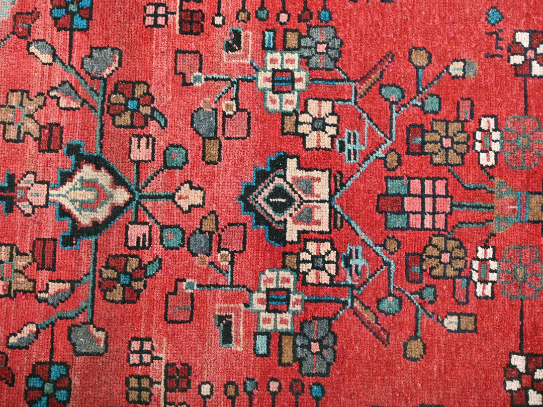 a close up of a red oriental rug