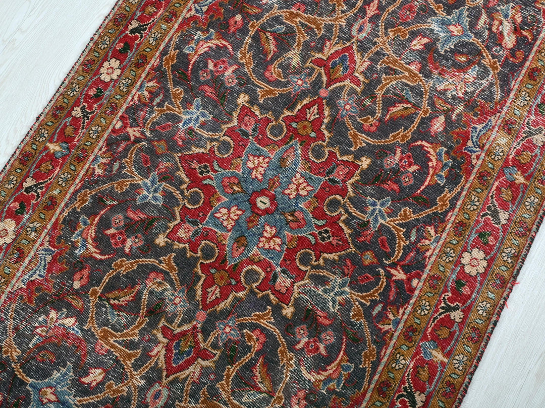 a red and blue rug on a white floor