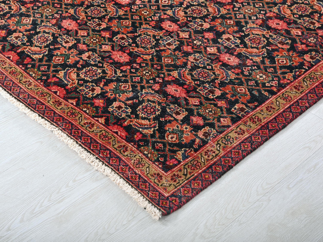 a black rug with a red and blue design on it