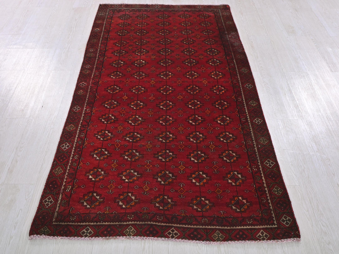 a red rug is laying on a white floor