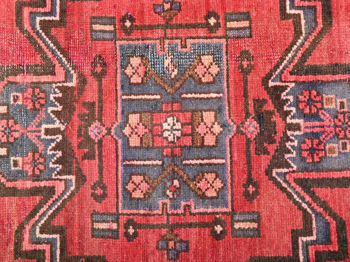 a close up of a rug with a red background