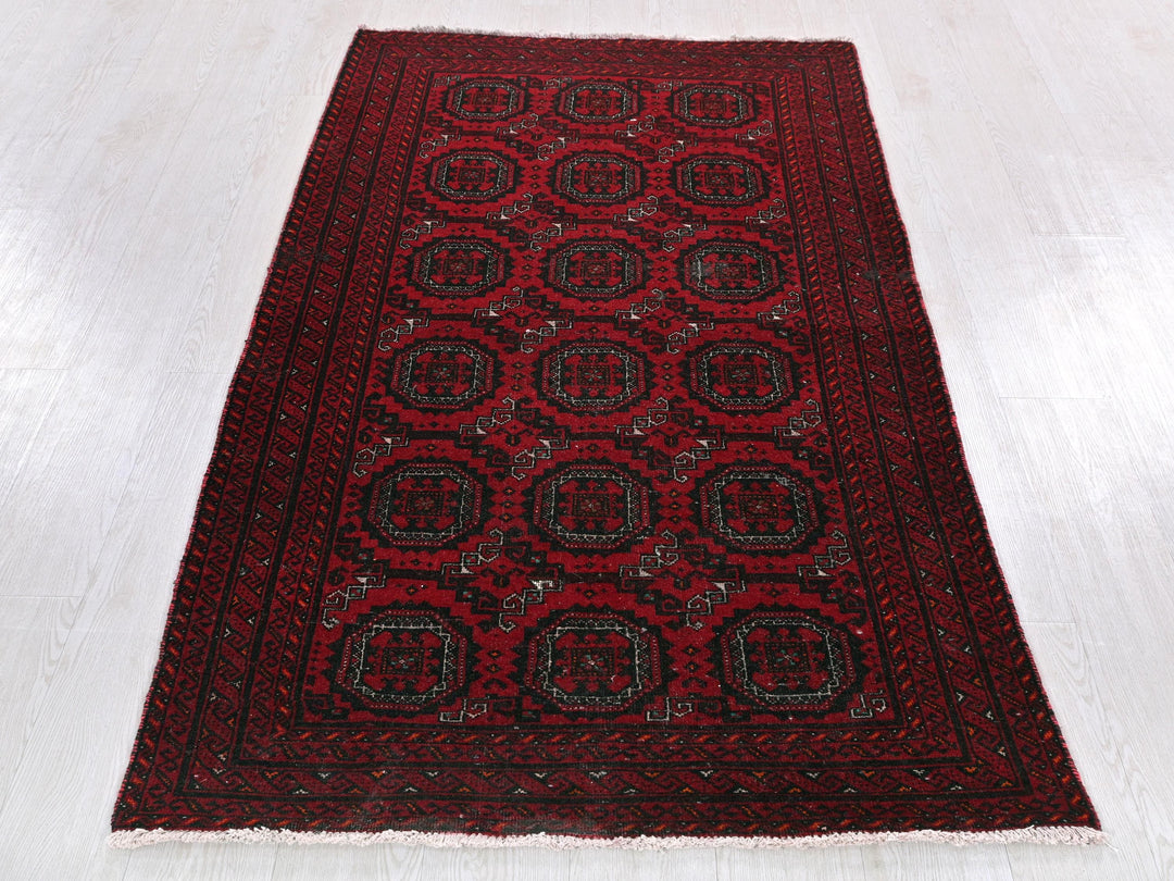 a red rug on a white wooden floor