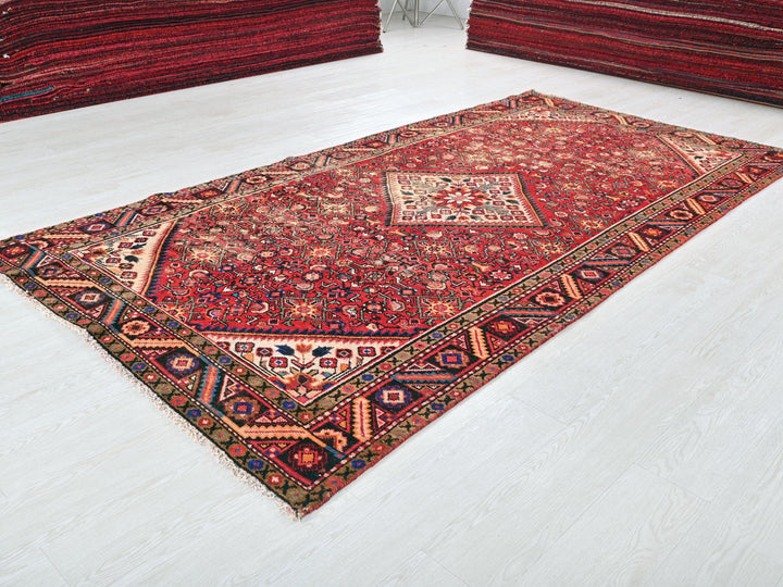 a large red rug on a white floor