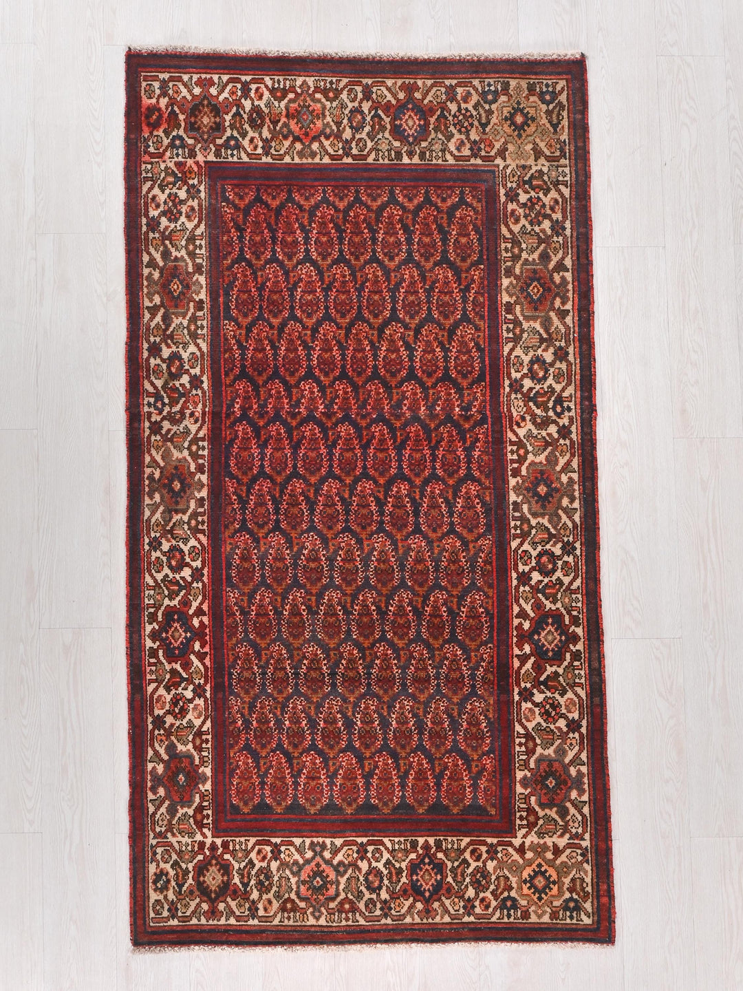 a red rug with a design on the middle of it
