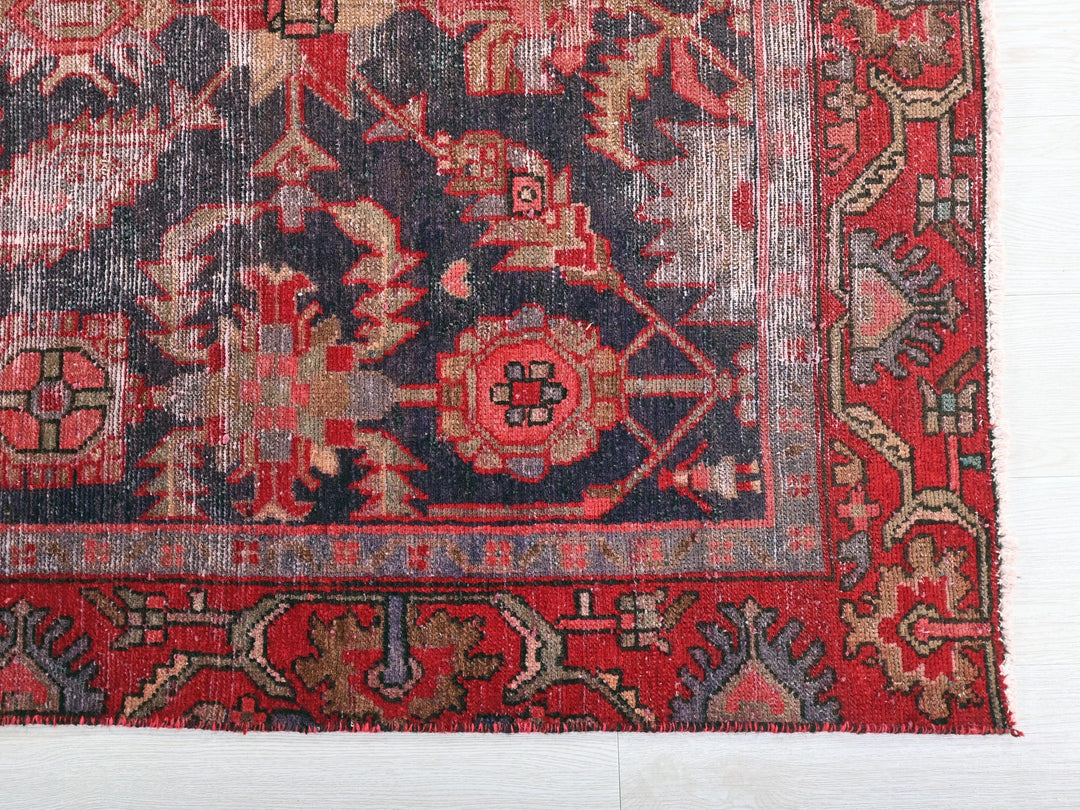 a red and blue rug with a design on it