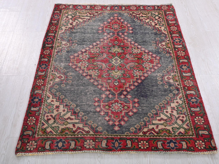 a red and blue rug on a white floor