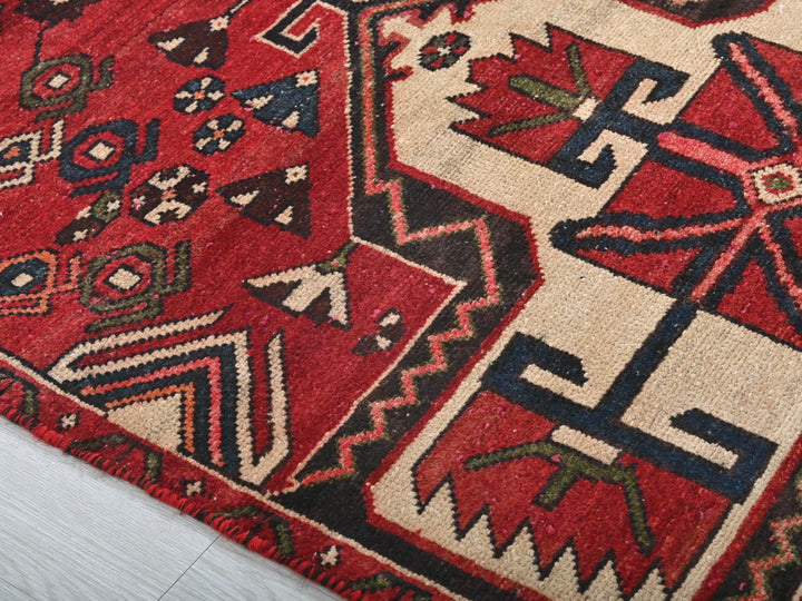 a close up of a red rug on the floor