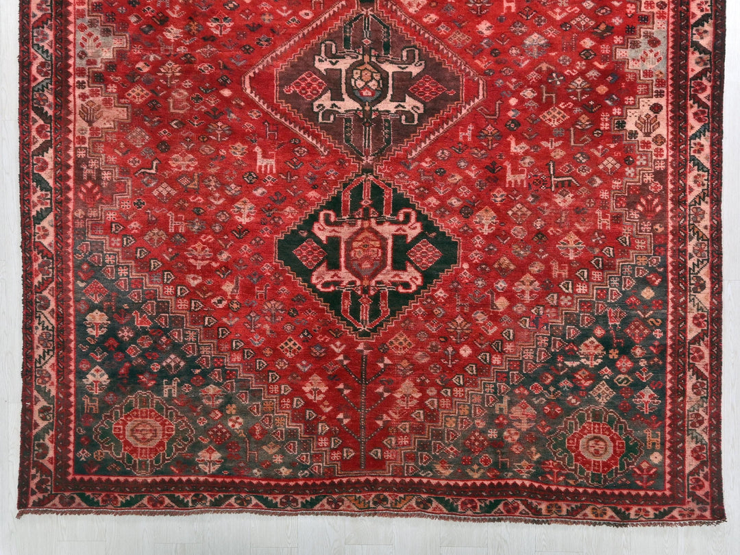 a red and black rug with a design on it