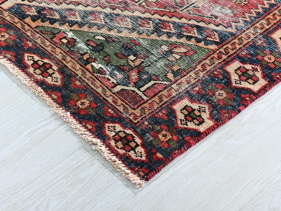 a red and blue rug on a white floor