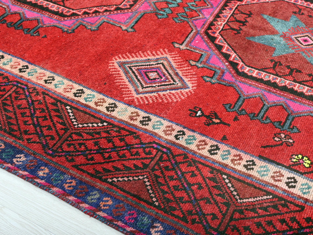 a close up of a red oriental rug