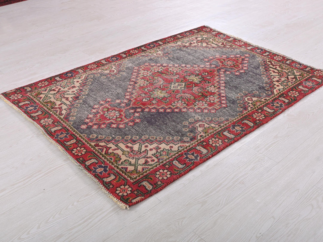 a red and blue rug on a white floor