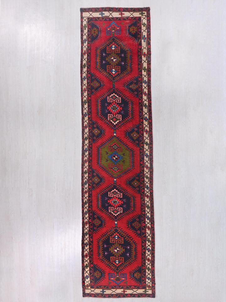 a red rug hanging on a wall