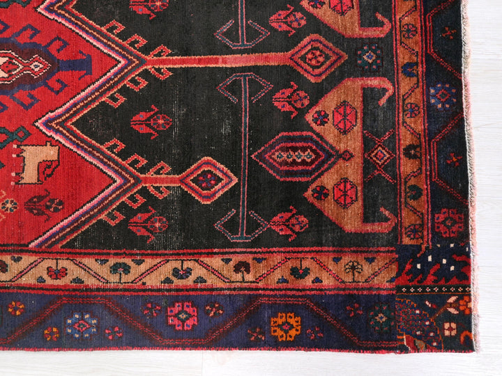a black and red rug on a white surface