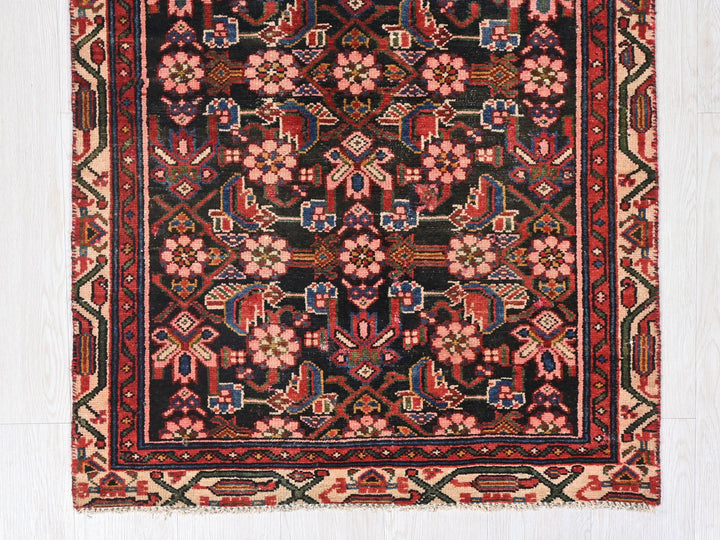 a rug with a floral design on a wooden floor