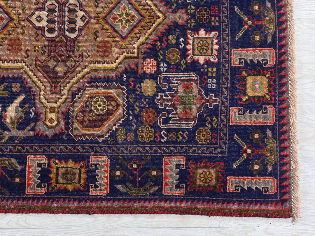 a blue rug with a colorful design on it