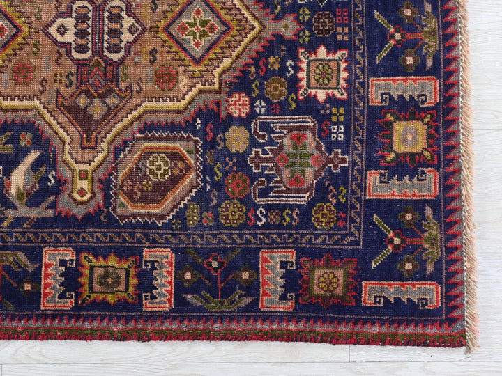 a blue rug with a colorful design on it