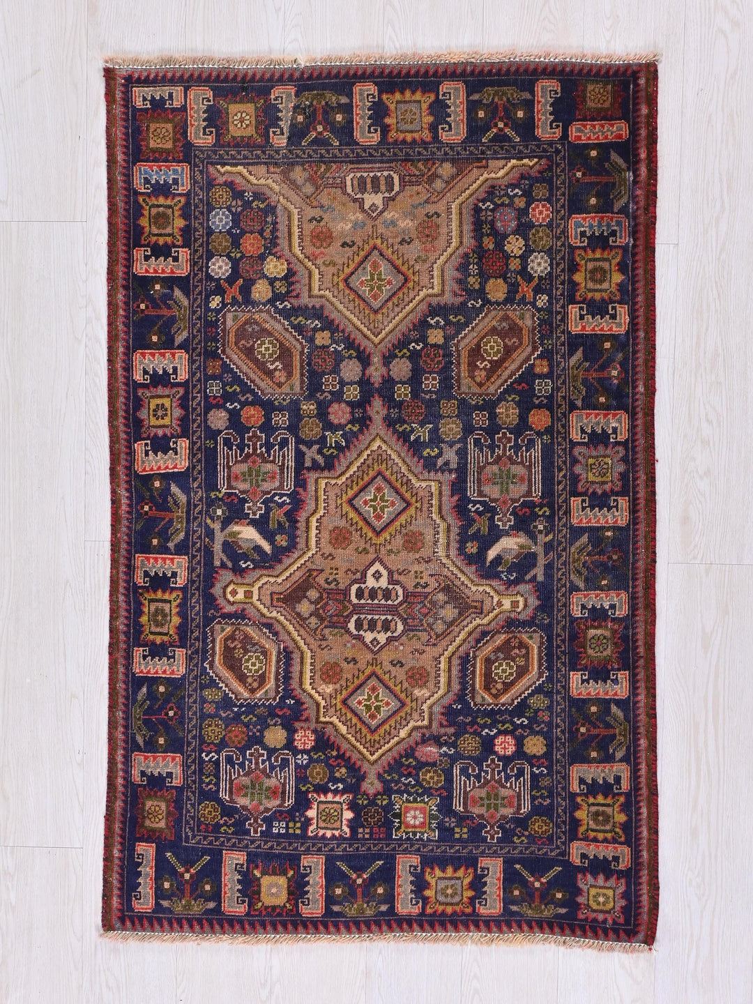 a blue and red rug on a wooden floor
