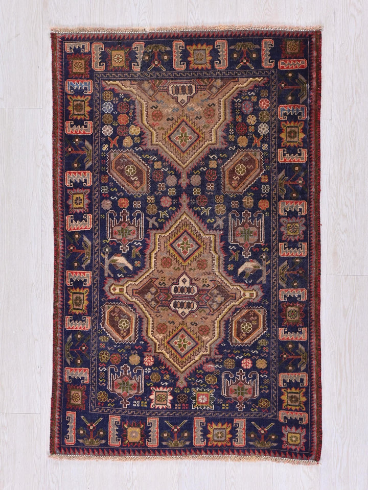 a blue and red rug on a wooden floor