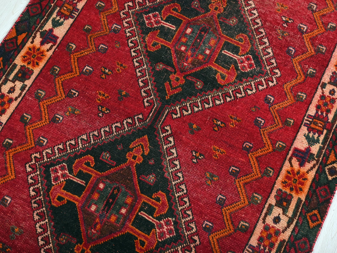 a close up of a red oriental rug