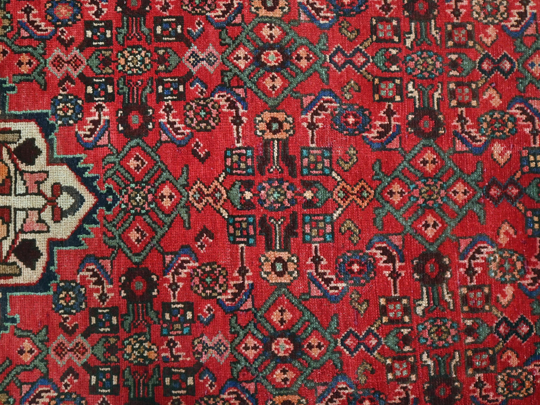 a red rug with a colorful design on it