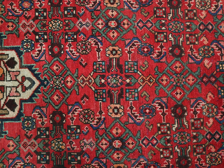 a red rug with a colorful design on it