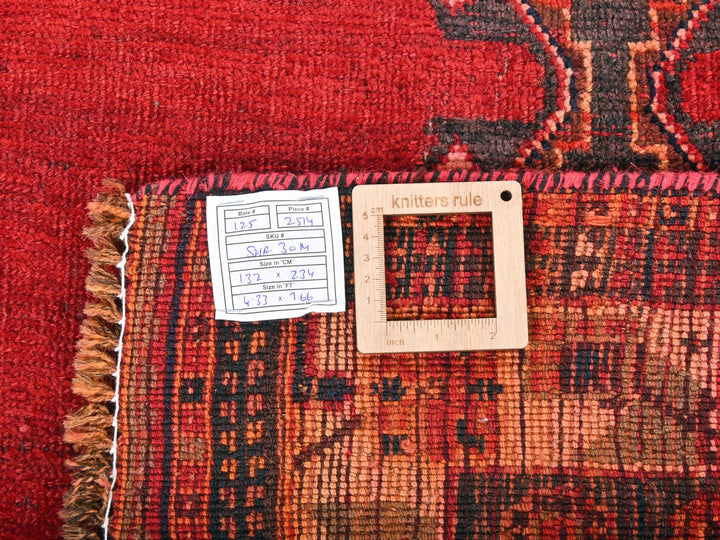 a red rug with a picture frame on top of it