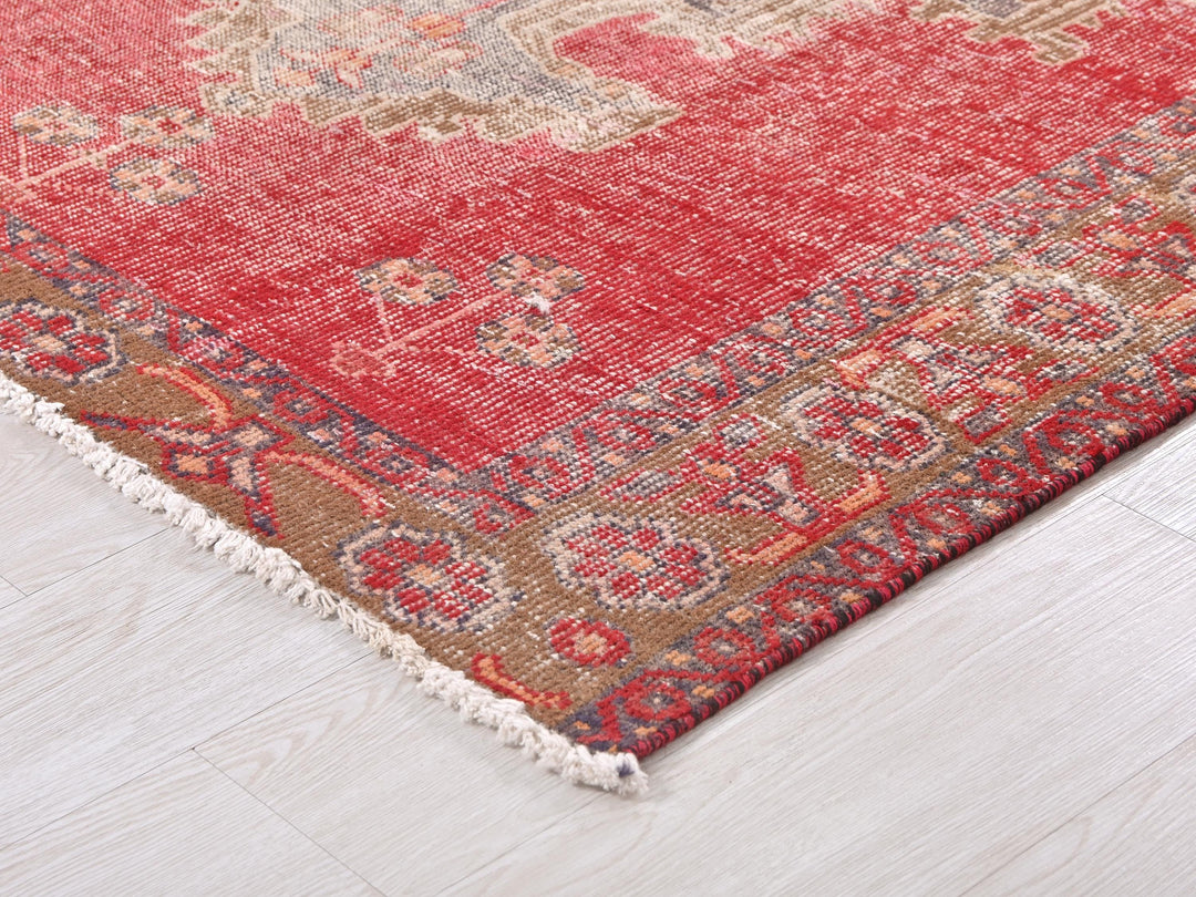 a red rug on a white wooden floor