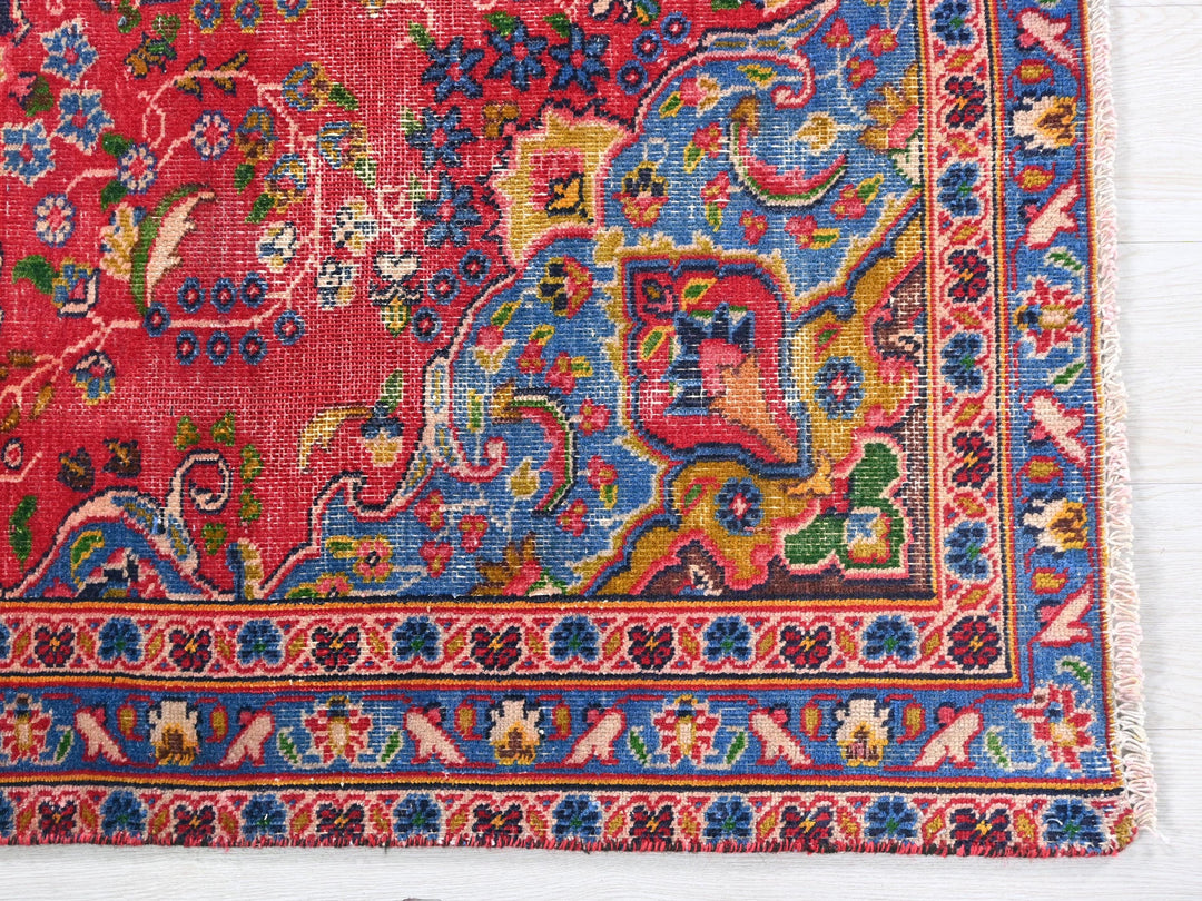 a red rug with a colorful design on it