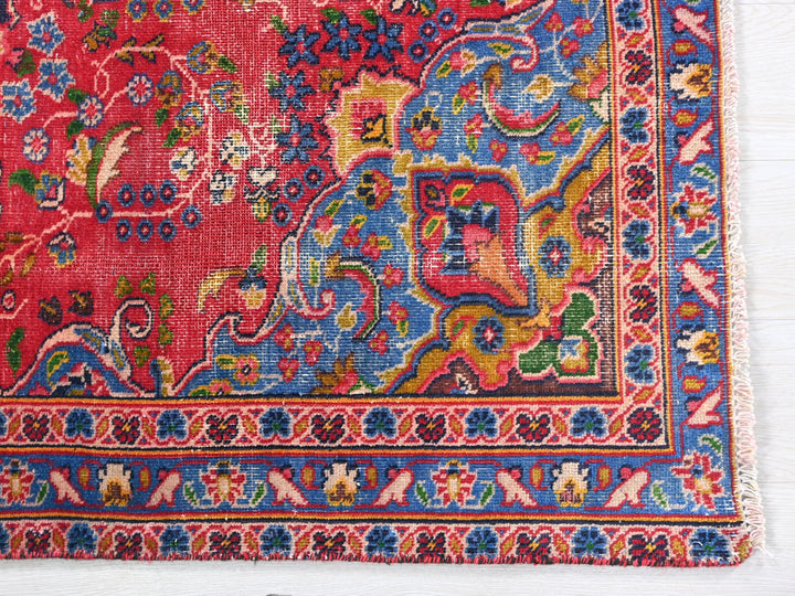 a red rug with a colorful design on it