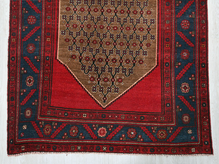 a red rug with a blue border on a white floor