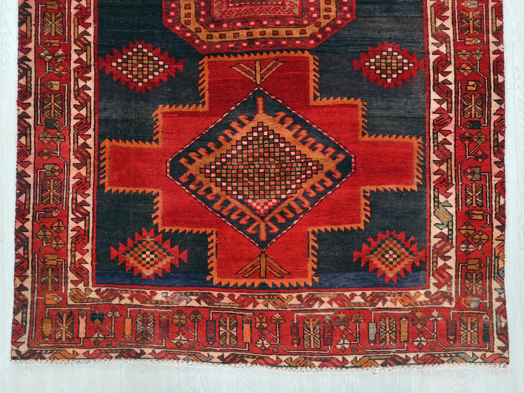 a red and blue rug with a diamond design