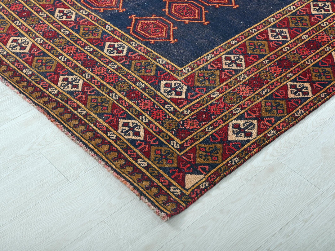 a blue and red rug on a white floor