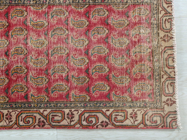 a red rug with a pattern on it