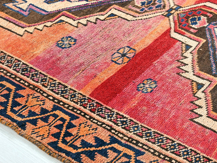 a multi colored rug with a pattern on it