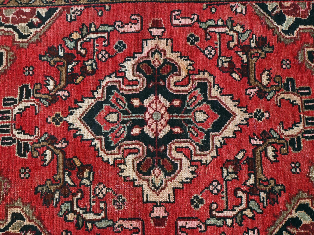 a red rug with a black and white design on it