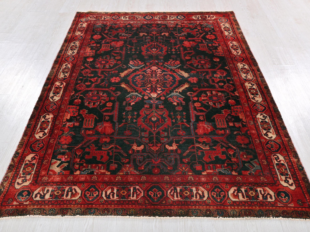 a red and black oriental rug on a white floor