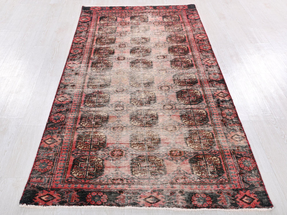 a red and black rug on a white floor