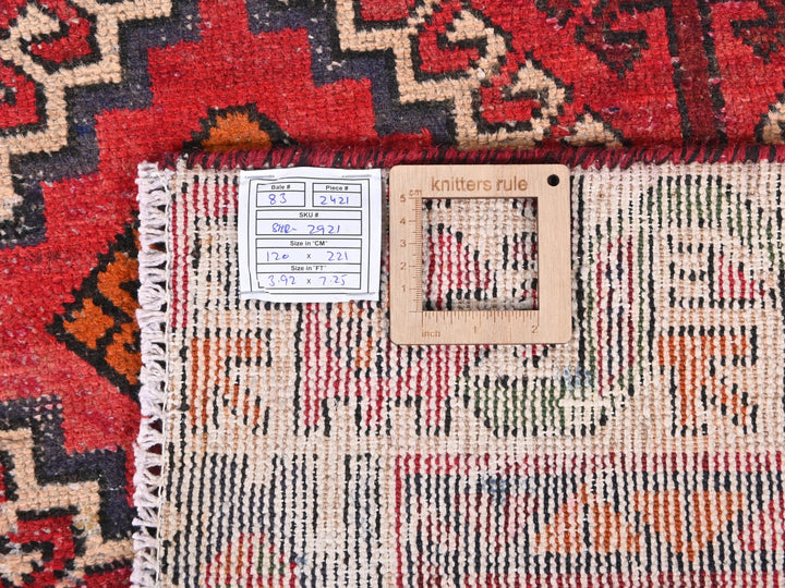 a red rug with a ruler on top of it
