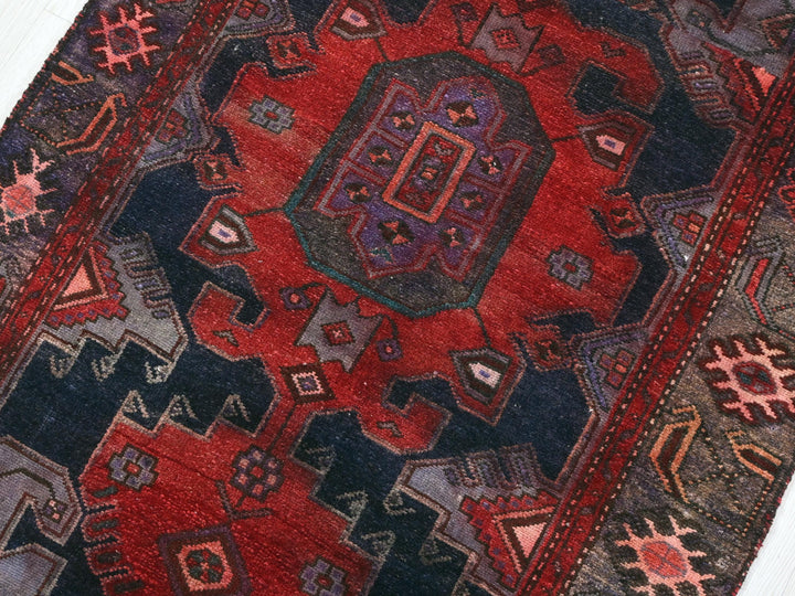 a red and black rug with a design on it