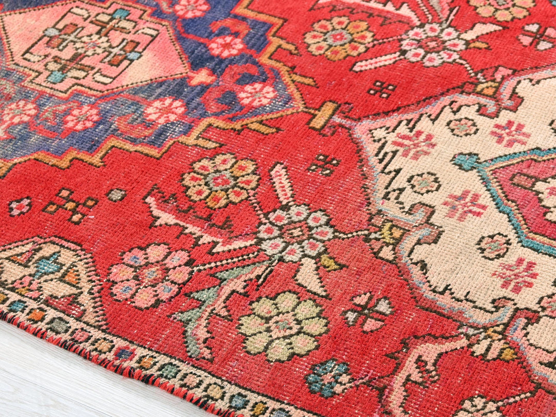 a close up of an oriental rug on a wooden floor