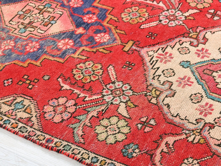 a close up of an oriental rug on a wooden floor
