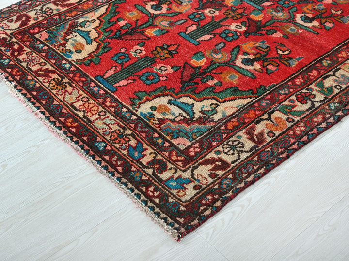 a red oriental rug on a white floor