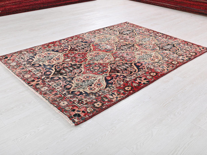 a red and blue rug on a white floor