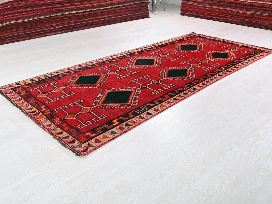 a red rug is laying on the floor