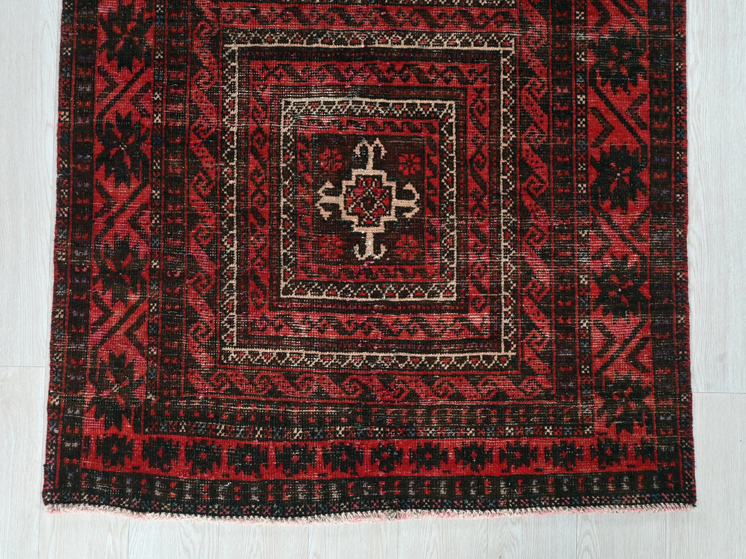 a red rug with a square design on it