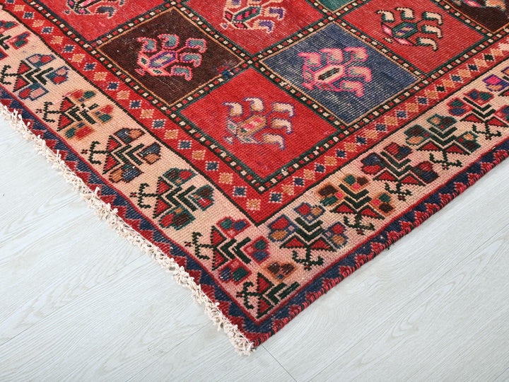 a red rug with a pattern on the middle of it